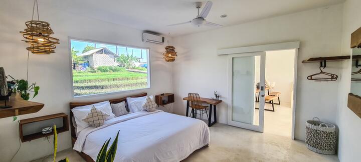 King bedroom with picture window and work desk